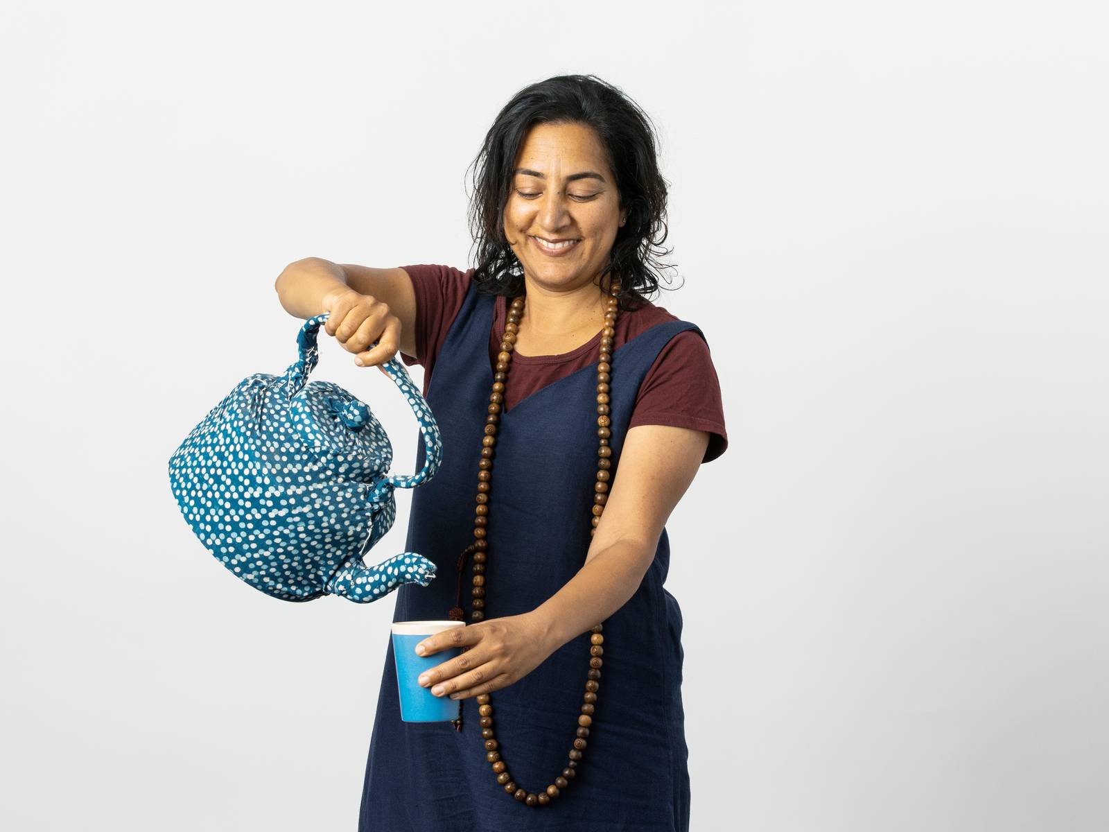 Meena pouring a cup of tea